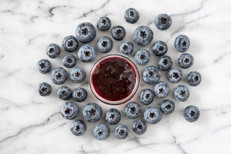 Homemade blueberries and jam on white marbleの写真素材