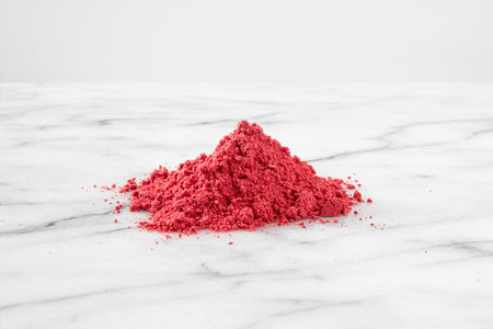Dehydrated raspberry powder with raspberries on the sideの写真素材