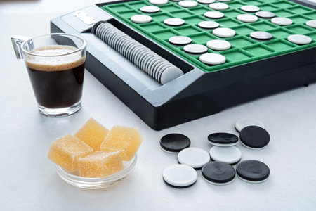 Fruit pasta and coffee in front of a game of Othello for a moment of relaxation and reflectionの写真素材