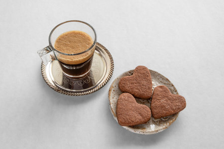 Cup of coffee and heart-shaped cookies for Valentine's Dayの写真素材