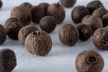 Allspice seeds close-up on white backgroundの写真素材