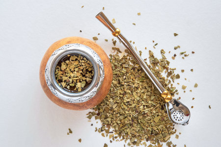 Yerba mate tea in a clay pot on a white backgroundの写真素材