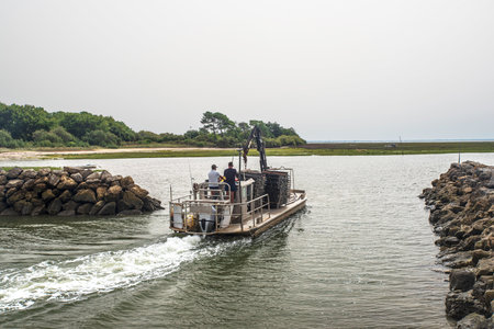 Oyster-growing boat leaves the harbor in the Arcachon basin in France