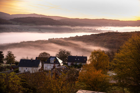 Autumn landscape in Burgundy at ChÃ¢teau-Chinon in France, with forests, hills and houses at sunriseの写真素材