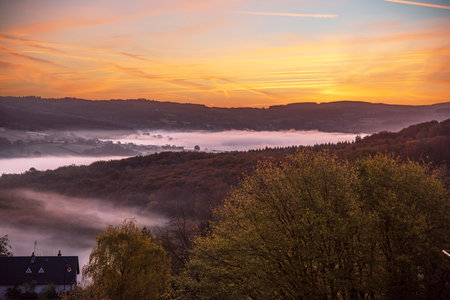 Autumn landscape in Burgundy at ChÃ¢teau-Chinon in France, with forests, hills and houses at sunriseの写真素材