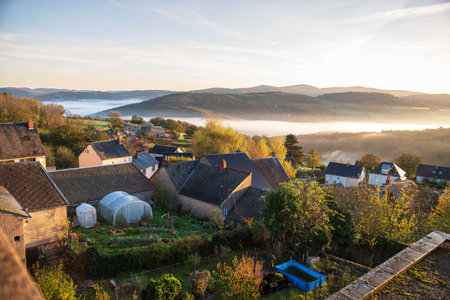 Autumn landscape in Burgundy at ChÃ¢teau-Chinon in France, with hills and houses at sunriseの写真素材