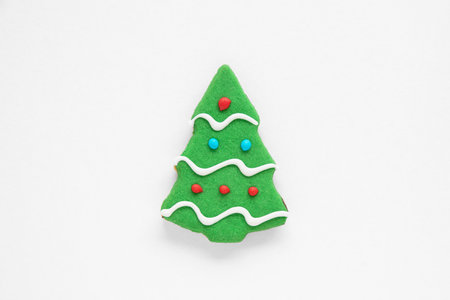 Christmas gingerbread cakes in the shape of a fir tree, colored in red, green and whiteの写真素材