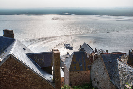 Sea and town of Mont Saint-Michel in Normandy, Franceの写真素材