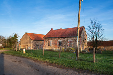 Burgundy landscape with farm, fields and trees in winterの写真素材