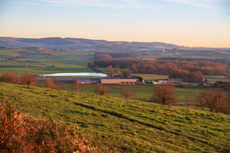 Cultivated field and farm in a Burgundy landscape in France