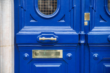 Detail of an entrance door handle with a letterbox and brass handle from an old building in Paris, Franceの写真素材