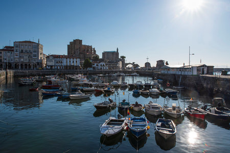 The port with small fishing boats and the architecture of the town of Castro Urdiales in Spainの写真素材