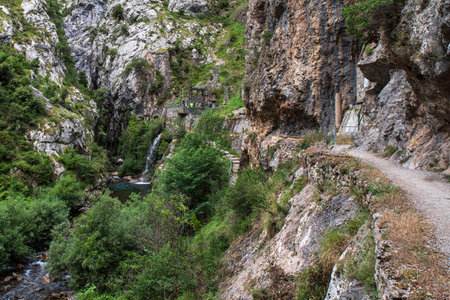 Mountain dam in the Cares gorges in Spain, with its rocky cliffs and vegetationの写真素材