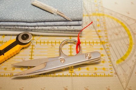 cutter, scissors, square and needles for patchwork
