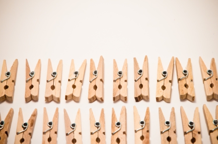 small clothespins ordered in two rowsの写真素材