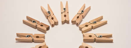 small clothespins ordered in a circle on whiteの写真素材