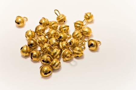 group of little golden bells on whiteの写真素材