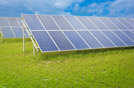 blue solar panels in a green fieldの写真素材