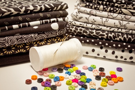 tools for patchwork with fabrics in black and white and buttonsの写真素材
