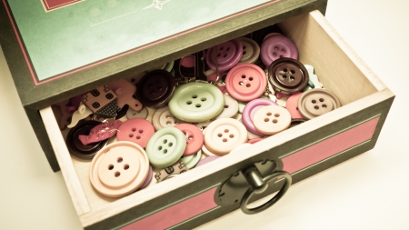 vintage box full of buttons for sewingの写真素材