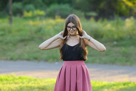 Woman with long hair and beautiful eyes on a green background shows the different human emotions. Lady portrays straightens hairの写真素材