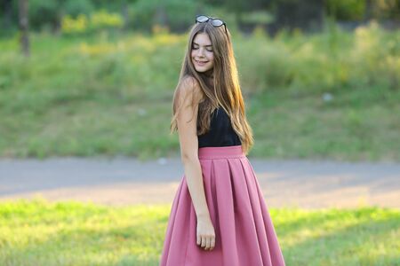 Woman with long hair and beautiful eyes on a green background shows the different human emotions. Lady portrays joy, smileの写真素材