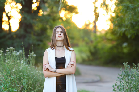 Woman with long hair and beautiful eyes on a green background shows the different human emotions. Lady portrays resentment, quarrel, sadnessの写真素材