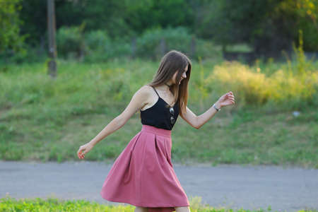 Woman with long hair and beautiful eyes on a green background shows the different human emotions. Lady portrays dancing, jumping, fun, happiness, smileの写真素材