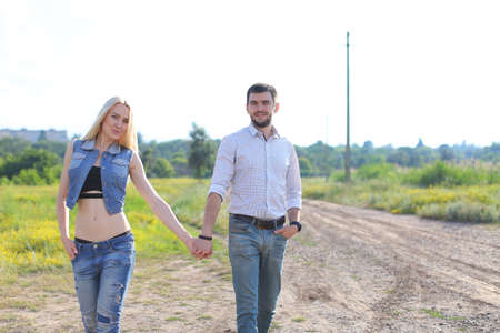 Young beautiful couple is embracing a man takes care of a woman happyの写真素材