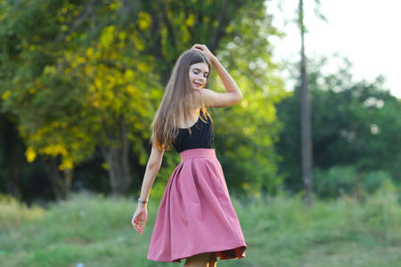 Woman with long hair and beautiful eyes on a green background shows the different human emotions. Lady portrays dancing, jumping, fun, happiness, smileの写真素材