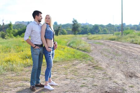 Young beautiful couple is embracing a man takes care of a woman happyの写真素材