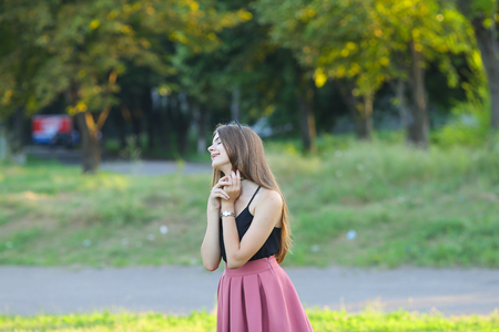 Woman with long hair and beautiful eyes on a green background shows the different human emotions. Lady portrays joy, happiness, fun, dancing, surprise, mercyの写真素材