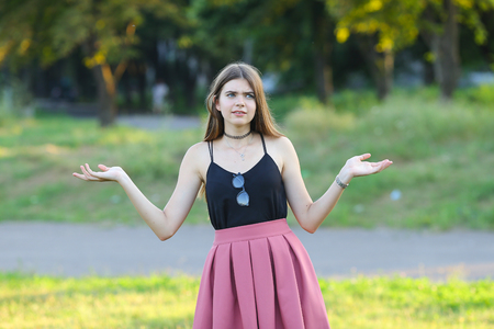 Woman with long hair and beautiful eyes on a green background shows the different human emotions. Lady portrays confusion, anger, howの写真素材