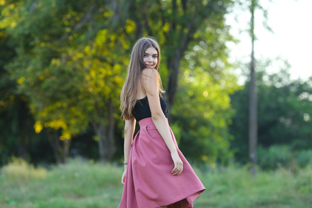 Woman with long hair and beautiful eyes on a green background shows the different human emotions. Lady portrays dancing, jumping, fun, happiness, smileの写真素材