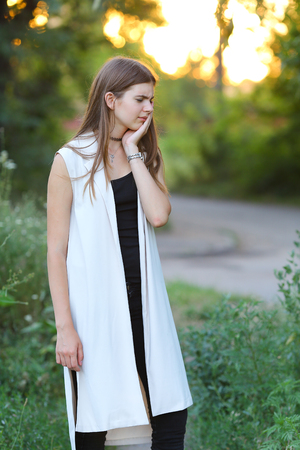 Woman with long hair and beautiful eyes on a green background shows the different human emotions. Lady portrays disgust, disgust, sadness, sorrowの写真素材