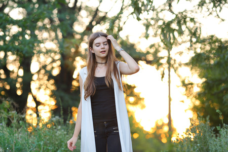 Woman with long hair and beautiful eyes on a green background shows the different human emotions. Lady portrays joy, lightness, ease, delight, happinessの写真素材