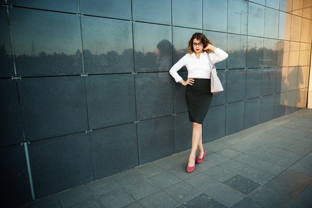 Young beautiful woman in suit lady female business clothes looking at camera smiling. Business concept, success, negotiations and meetings.の写真素材