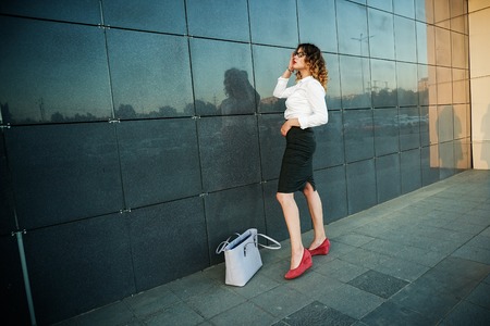 Young beautiful woman in suit lady female business clothes looking at camera smiling. Business concept, success, negotiations and meetings.の写真素材