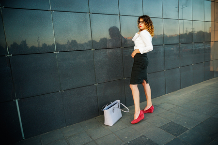Young beautiful woman in suit lady female business clothes looking at camera smiling. Business concept, success, negotiations and meetings.の写真素材