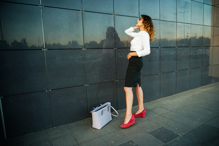 Young beautiful woman in suit lady female business clothes looking at camera smiling. Business concept, success, negotiations and meetings.の写真素材