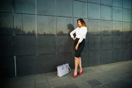 Young beautiful woman in suit lady female business clothes looking at camera smiling. Business concept, success, negotiations and meetings.の写真素材
