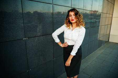 Young beautiful woman in suit lady female business clothes looking at camera smiling. Business concept, success, negotiations and meetings.の写真素材
