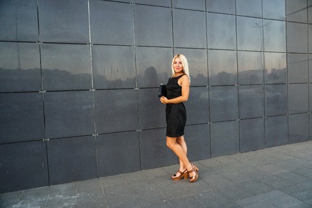 Young beautiful woman in suit lady female business clothes looking at camera smiling. Business concept, success, negotiations and meetings.の写真素材