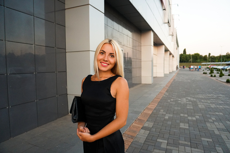 Young beautiful woman in suit lady female business clothes looking at camera smiling. Business concept, success, negotiations and meetings.の写真素材