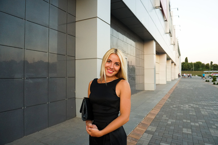 Young beautiful woman in suit lady female business clothes looking at camera smiling. Business concept, success, negotiations and meetings.の写真素材