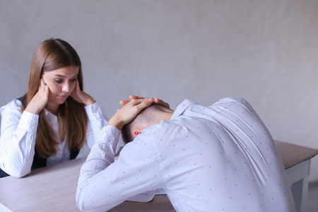 Female Tells Male About Work and New Ideas. International Company Enters Into Bargain With His Partner to Success of Common Cause. Young Man of European Appearance With White Hair in White Shirt and Young Woman of European Appearance With Brown Long Hair の写真素材