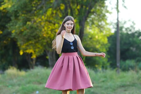 Woman with long hair and beautiful eyes on a green background shows the different human emotions. Lady portrays dancing, jumping, fun, happiness, smileの写真素材