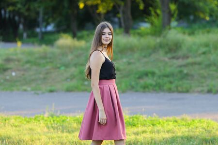 Woman with long hair and beautiful eyes on a green background shows the different human emotions. Lady portrays fun, happiness, smile, blissの写真素材
