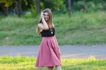 Woman with long hair and beautiful eyes on a green background shows the different human emotions. Lady portrays fun, happiness, smile, blissの写真素材