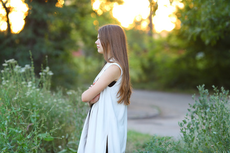 Woman with long hair and beautiful eyes on a green background shows the different human emotions. Lady portrays resentment, quarrel, sadnessの写真素材